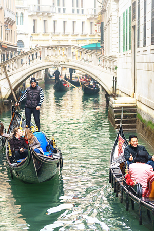 VENICE, ITALY - 02.23.2019: Happy faces of people in gondolas on Grand Canal during the famous carnival in Venice. Selective focusのeditorial素材