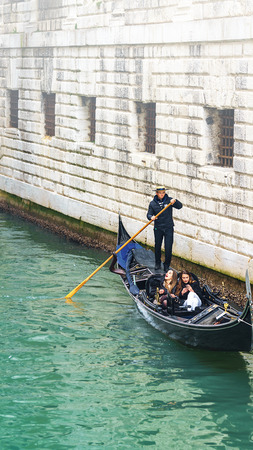 VENICE, ITALY - 02.23.2019: Happy faces of people in gondolas on Grand Canal during the famous carnival in Venice. Selective focusのeditorial素材