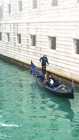 VENICE, ITALY - 02.23.2019: Happy faces of people in gondolas on Grand Canal during the famous carnival in Venice. Selective focusのeditorial素材