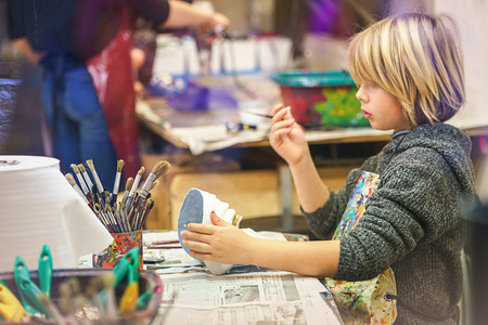 VENICE, ITALY - 02.23.2019: Happy face of little boy hands with venice tradition carnival mask, painting, making of mask during the carnival in Venice. Selective focusのeditorial素材