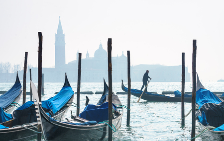 VENICE, ITALY - 02.23.2019: Venice Panorama with nice gondolas. Panoramic cityscape image Venice, Italy and waterfront Saint Mark square and San Giorgio Maggiore church in background in morning light.のeditorial素材