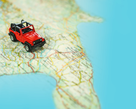 Travel on the road with map. Car travel and road trip. Concept of journey and rent a car, lifestyle. Selective focus, close-up, copy space.の写真素材