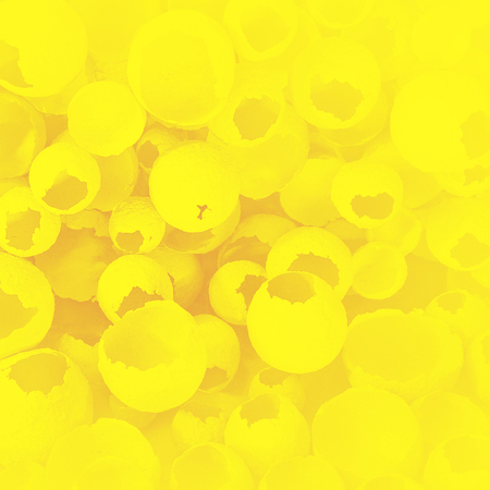 Cracked eggs pattern as colorful yellow background. Top view, flat lay, selective focus. Easter creative minimal concept. Eggshell texture for art background.の写真素材