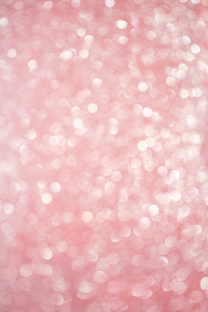 Blurred bokeh light red pink coral background, Christmas and New Year holidays background. Party concept. Festive holiday card bright backdrop. Defocused. Flat lay, top view, copy space.の写真素材