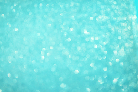 Blurred bokeh light blue background, Christmas and New Year holidays background. Party concept. Festive holiday card bright backdrop. Defocused. Flat lay, top view, copy space.の写真素材