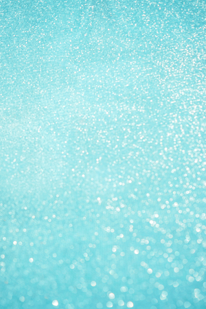 Blurred bokeh light blue background, Christmas and New Year holidays background. Party concept. Festive holiday card bright backdrop. Defocused. Flat lay, top view, copy space.の写真素材