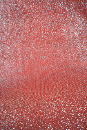 Blurred bokeh light red pink coral background, Christmas and New Year holidays background. Party concept. Festive holiday card bright backdrop. Defocused. Flat lay, top view, copy space.の写真素材