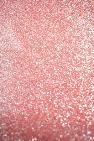 Blurred bokeh light red pink coral background, Christmas and New Year holidays background. Party concept. Festive holiday card bright backdrop. Defocused. Flat lay, top view, copy space.の写真素材