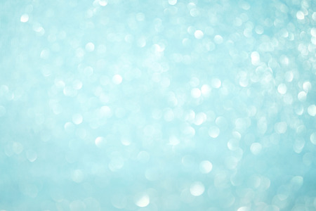 Blurred bokeh light blue background, Christmas and New Year holidays background. Party concept. Festive holiday card bright backdrop. Defocused. Flat lay, top view, copy space.の写真素材