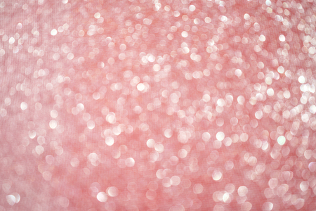 Blurred bokeh light red pink coral background, Christmas and New Year holidays background. Party concept. Festive holiday card bright backdrop. Defocused. Flat lay, top view, copy space.の写真素材