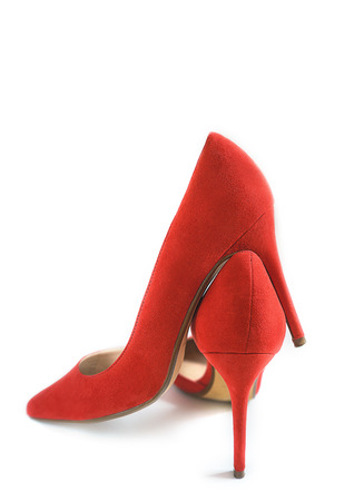 Fashion female red high heel shoes on white background, isolated. Christmas and Happy New Year, Valentines Day Party concept outfit. Copy space.の写真素材