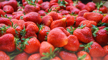 Strawberries in wooden boxes baskets texture at the green market.の写真素材