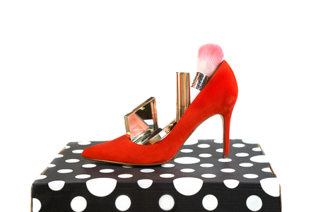 Trendy outfit layout red shoes accessories makeup cosmetics on black and white box and whiteの写真素材