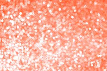 Bokeh blurred pink coral background, Christmas and New Year holidays background. Party concept. Festive holiday card bright backdrop. Defocused. Flat lay, top view, copy space.の写真素材