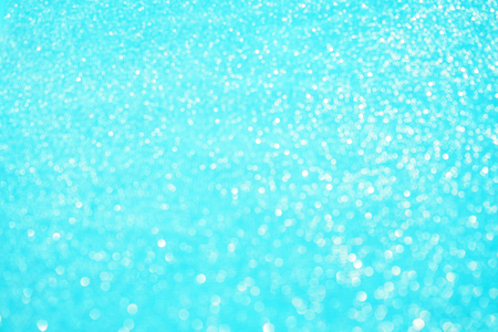 Blurred bokeh light blue background, Christmas and New Year holidays background. Party concept. Festive holiday card bright backdrop. Defocused. Flat lay, top view, copy space.の写真素材