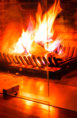 Burning fireplace. Wood burning in a cozy fireplace at home in interior.の写真素材