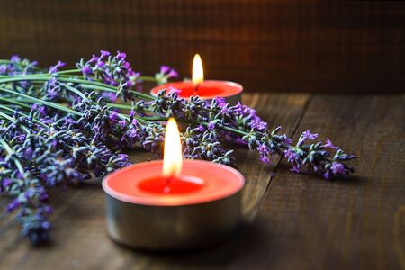Spa massage setting with lavender flowers, scented aroma candles on woodenの写真素材