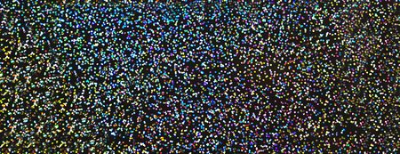Blurred bokeh light colorful holographic background, Christmas and New Year holidays dark background. Party concept. Festive holiday bright backdrop. Defocused.の写真素材