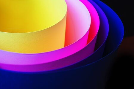 Trendy neon multicolor background from a arcs of cardboard different colors. Copy space. Back to school, party, celebration abstract concept. Minimal style.の写真素材