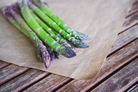 Fresh green asparagus on wooden table background. Healhty lifestyle concept. Close up, flat lay, top view.の写真素材