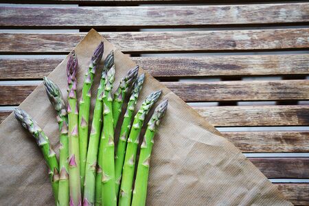 Fresh green asparagus on wooden table background. Healhty lifestyle concept. Close up, flat lay, top view.の写真素材