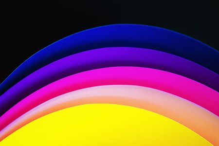 Trendy neon multicolor background from a arcs of cardboard different colors. Copy space. Back to school, party, celebration abstract concept. Minimal style.の写真素材