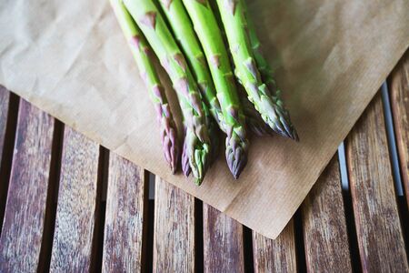 Fresh green asparagus on wooden table background. Healhty lifestyle concept. Close up, flat lay, top view.の写真素材