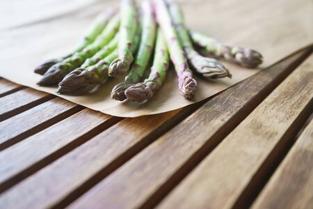 Fresh green asparagus on wooden table background. Healhty lifestyle concept. Close up, flat lay, top view.の写真素材