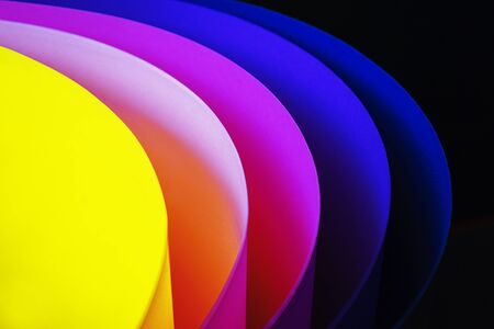Trendy neon multicolor background from a arcs of cardboard different colors. Copy space. Back to school, party, celebration abstract concept. Minimal style.の写真素材