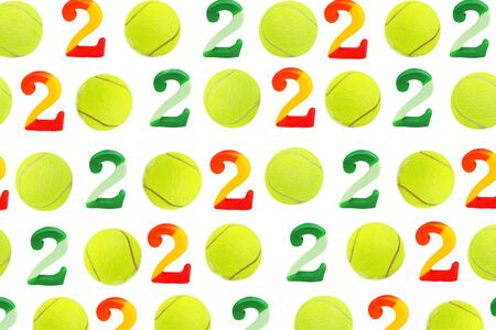 Tennis Christmas and 2020 New Year pattern with tennis balls and numbers on white snow, isolated. Top view, flat lay, copy space. Winter sport healthy layout. Holiday conception.の写真素材