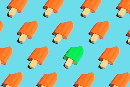 Colorful ice cream pattern on bright blue background. Pop art minimal flat lay style design, summer creative concept. Top view, flatlay. Copy space.の写真素材