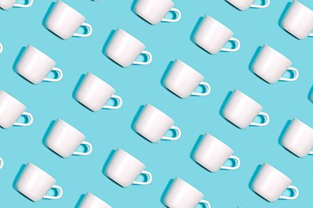 Coffee pattern of white cup for coffee on bright blue background. Pop art minimal flat lay style design, creative concept. Top view. Copy space. Banner.の写真素材