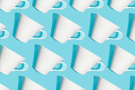 Coffee pattern of white cup for coffee on bright blue background. Pop art minimal flat lay style design, creative concept. Top view. Copy space. Banner.の写真素材
