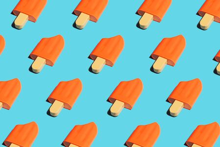Colorful ice cream pattern on bright blue background. Pop art minimal flat lay style design, summer creative concept. Top view, flatlay. Copy space.の写真素材
