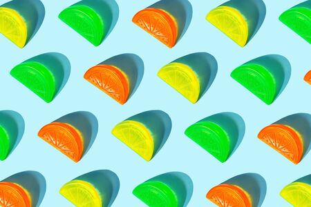 Creative pattern of colorful citrus slices like ice for cocktail on pastel blue background. Pop art minimal flat lay style design, summer drink creative concept. Top view, flatlay. Copy space.の写真素材