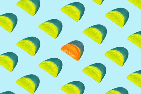 Creative pattern of yellow citrus lemon slices and orange as ice for cocktail on blue background. Pop art minimal flat lay style design, summer drink creative concept. Top view, flatlay. Copy space.の写真素材