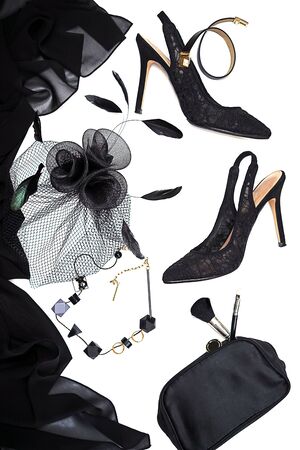 Halloween party female outfit collection accessories black on white background, shoes, cloth with skulls, hat, jewelry, make up, bag. Flat lay, top view, vertical, horizontal. Black Friday concept.の写真素材