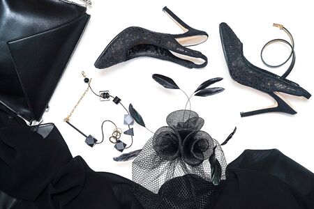 Halloween party female outfit collection accessories black on white background, shoes, cloth with skulls, hat, jewelry, make up, bag. Flat lay, top view, vertical, horizontal. Black Friday concept.の写真素材