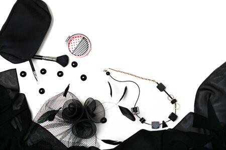 Halloween party female outfit collection accessories black on white background, shoes, cloth with skulls, hat, jewelry, make up, bag. Flat lay, top view, vertical, horizontal. Black Friday concept.の写真素材