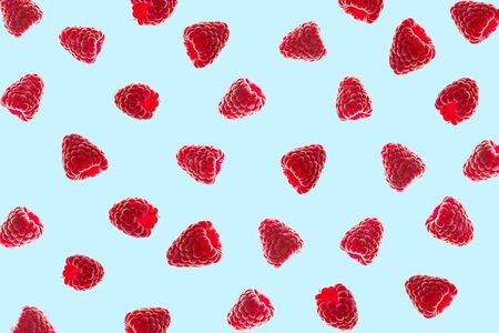 Creative pattern of red raspberries on blueの写真素材