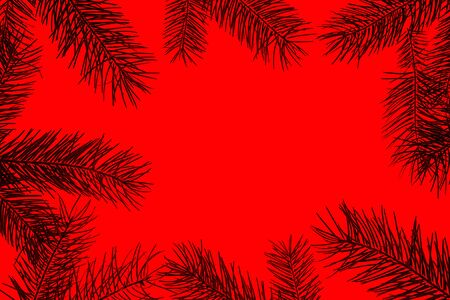 Creative Christmas composition made of green fir tree branches on redの写真素材