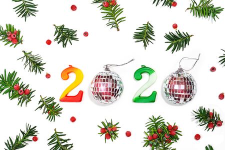 Happy New Year 2020 written on Christmas pattern made of fir branches with red berriesの写真素材