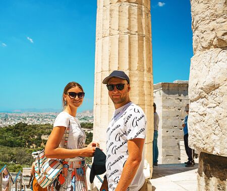 Couple is happy on ancient temple Parthenon in Acropolis Athens Greece and blue sky background. Couple is fun, exploring nice places. The best travel destinations.の写真素材