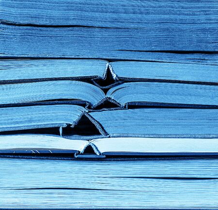 Classic blue color stack of old books background. Colour of the year 2020.の写真素材