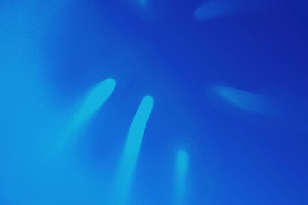 Bright Blue color tropical palm leaf shadow in trendy duotone neon background. Flat lay. Minimal summer concept with palm tree leaf. Classic Blue color 2020 concept. Copy space. Blurred.の写真素材