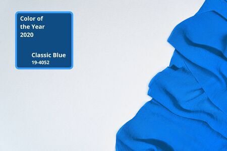 Blue color of the Year 2020 inscription. Faivorite colour of the New Year. Cloth colored in classic blue color. Concept for fashion, outfit, home design, interiors.の写真素材