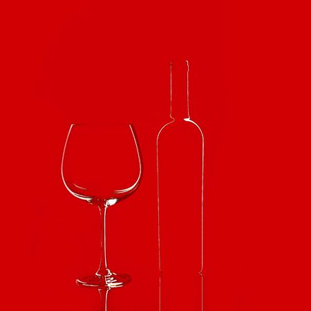 Empty wine glass and a bottle isolated on red background. Elegant red wine glass and a wine bottle. Valentine's day, Birthday concept.の写真素材