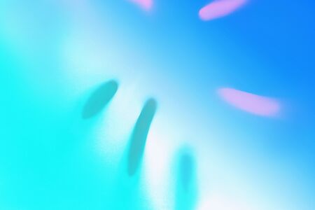 Bright Blue color tropical palm leaf shadow in trendy duotone pink mint green neon background. Flat lay. Minimal summer concept with palm tree. Classic Blue color 2020 concept. Blurred.の写真素材