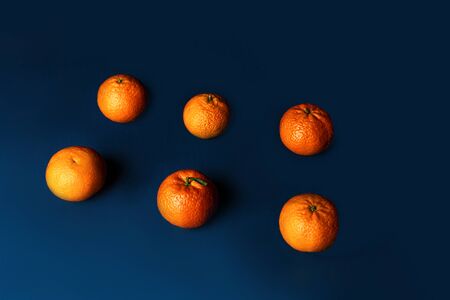 Composition with orange tangerines on a blue classic color background. Pattern, copy space. Classic Blue color 2020 concept.の写真素材