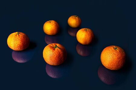 Composition with orange tangerines on a blue classic color background. Pattern, copy space. Classic Blue color 2020 concept.の写真素材